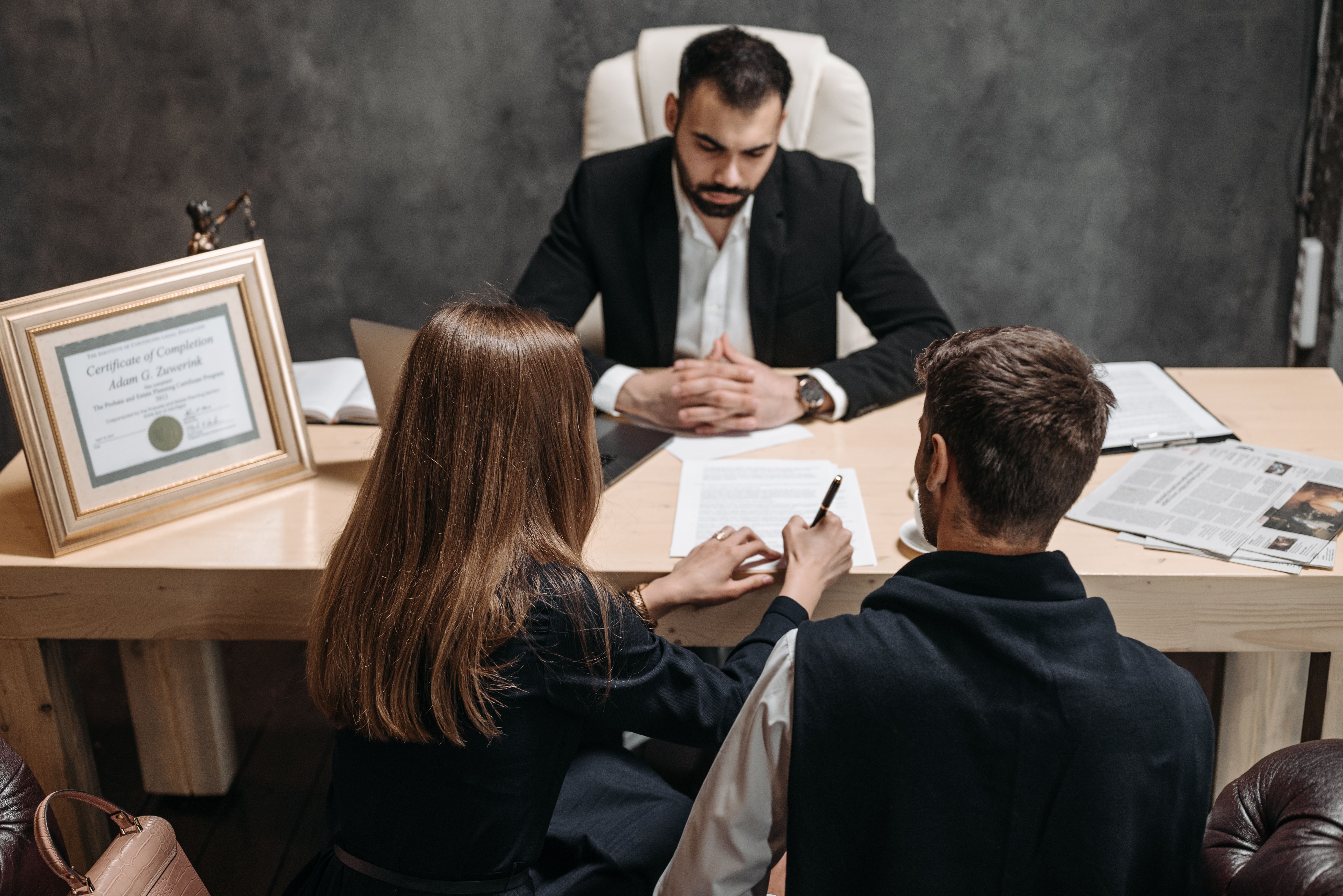 A lawyer discussing legal documents with clients during a case consultation.