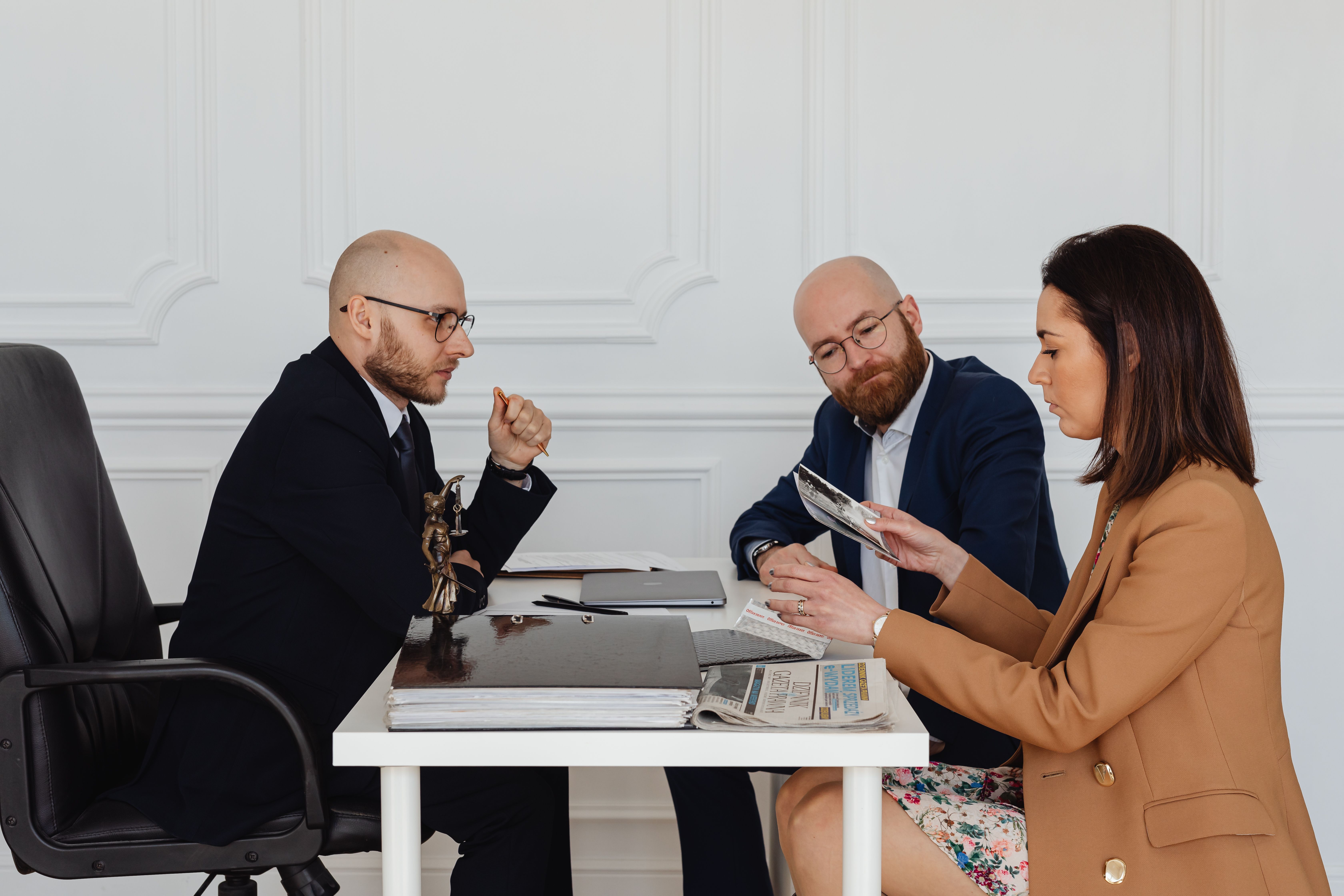 Group of professionals reviewing documents together in an office setting