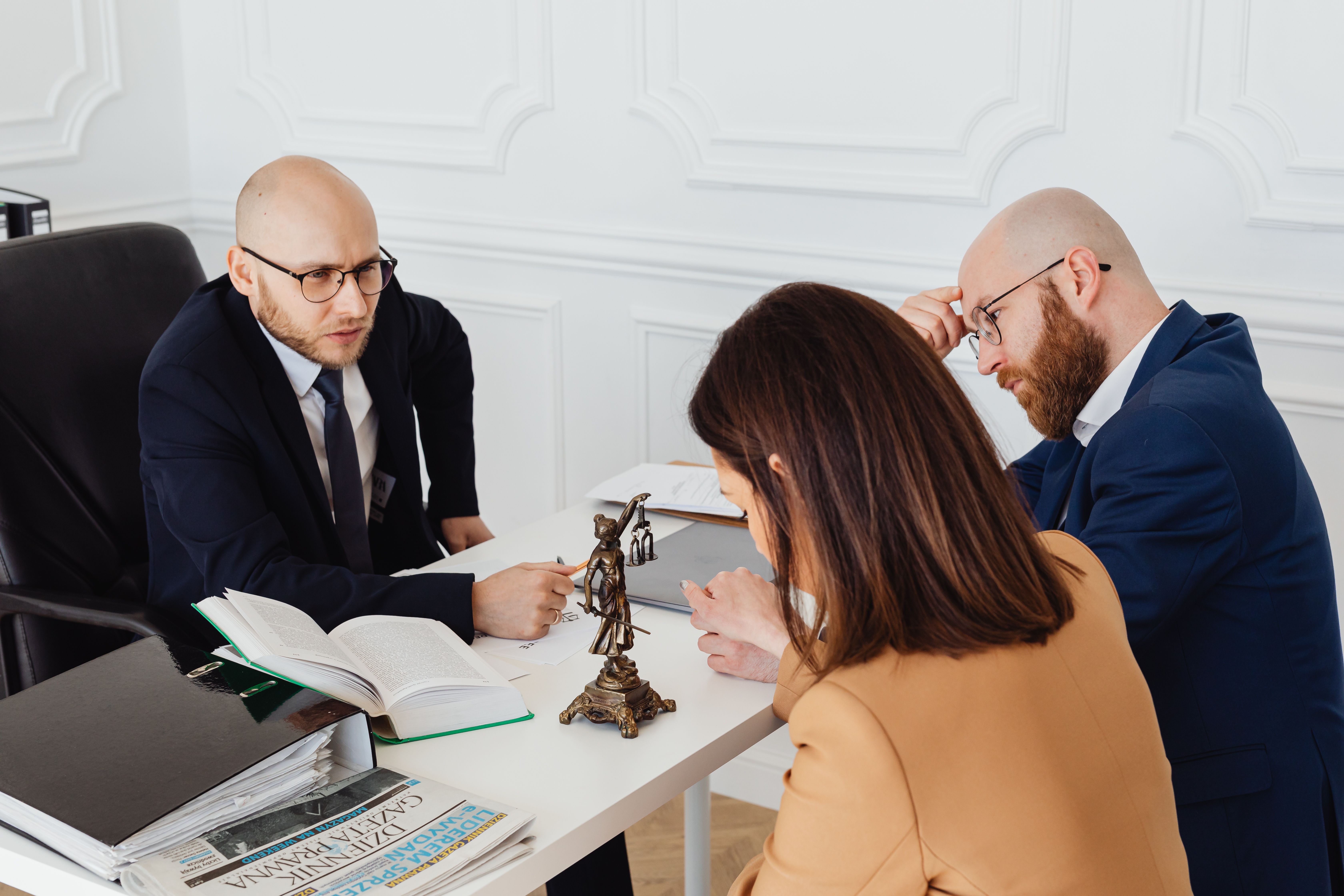 Lawyer consulting clients in a modern office during a serious discussion