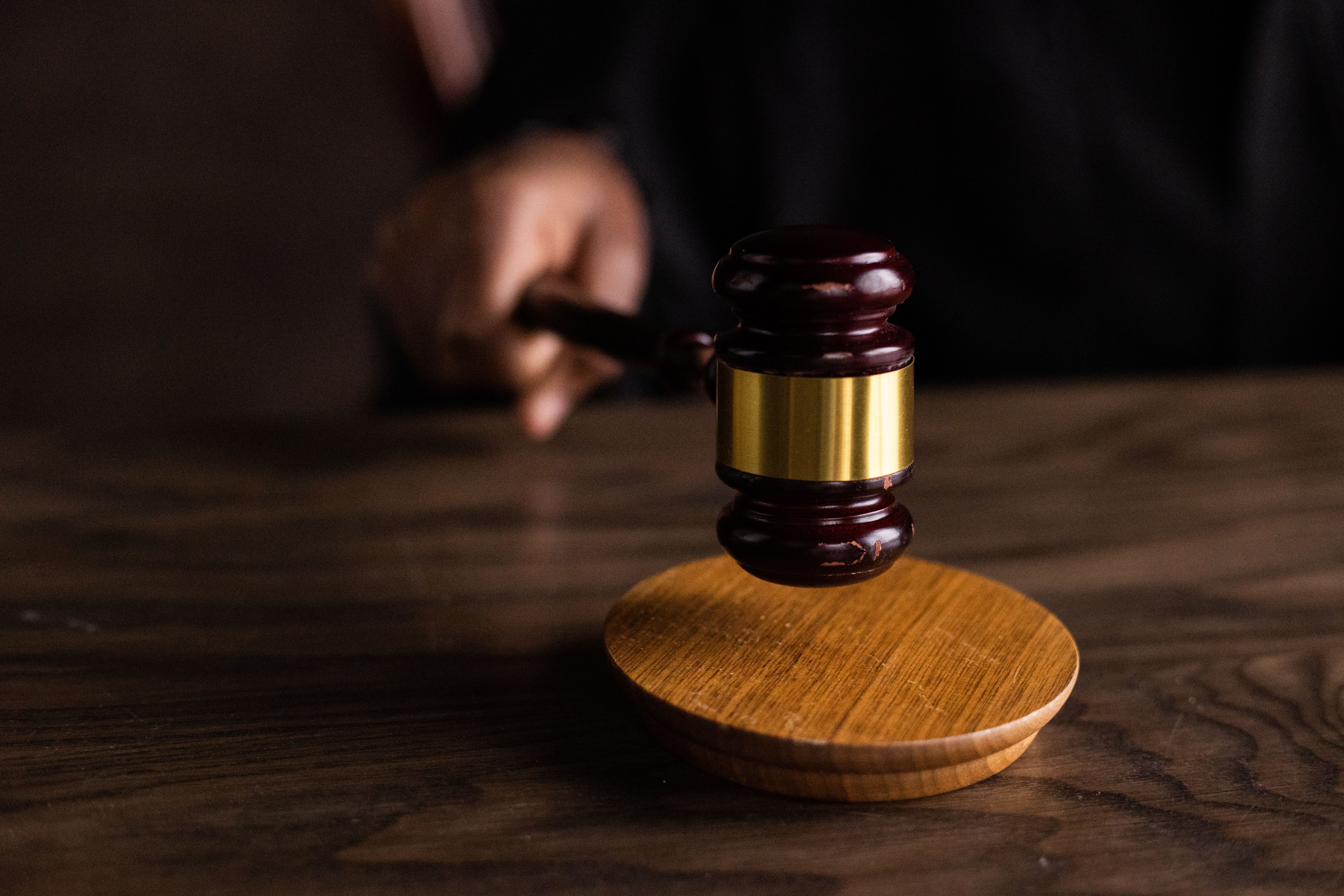 Gavel striking a sound block in a courtroom, symbolizing the resolution of funded legal claims